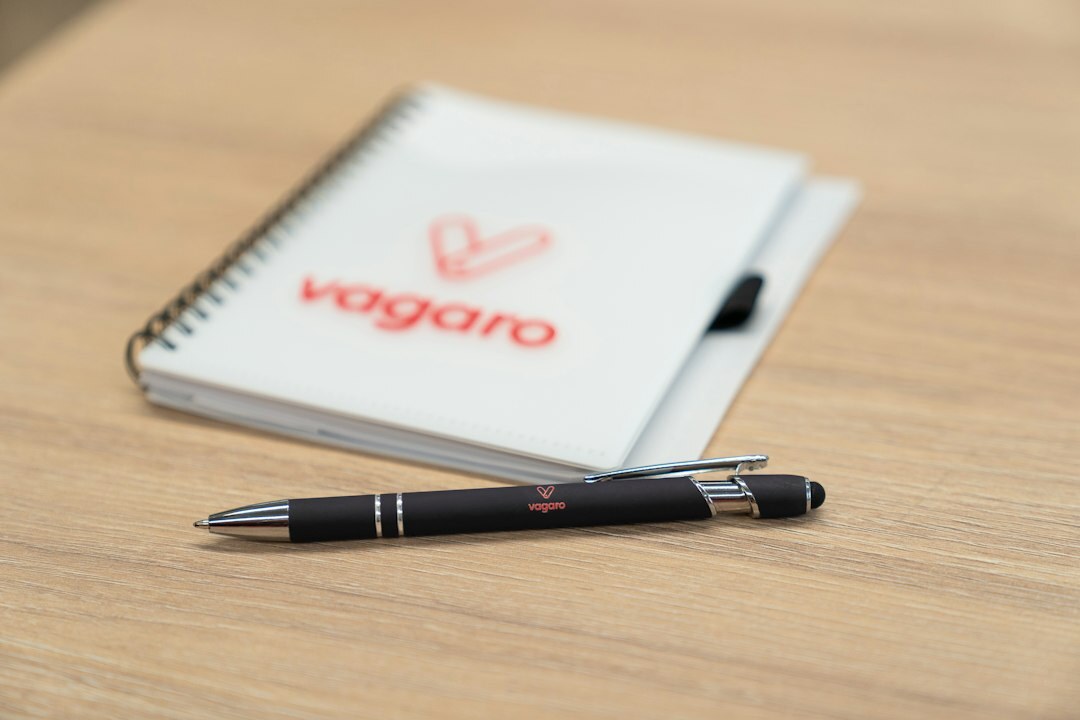Notebook and pen on a wooden table during a leadership workshop